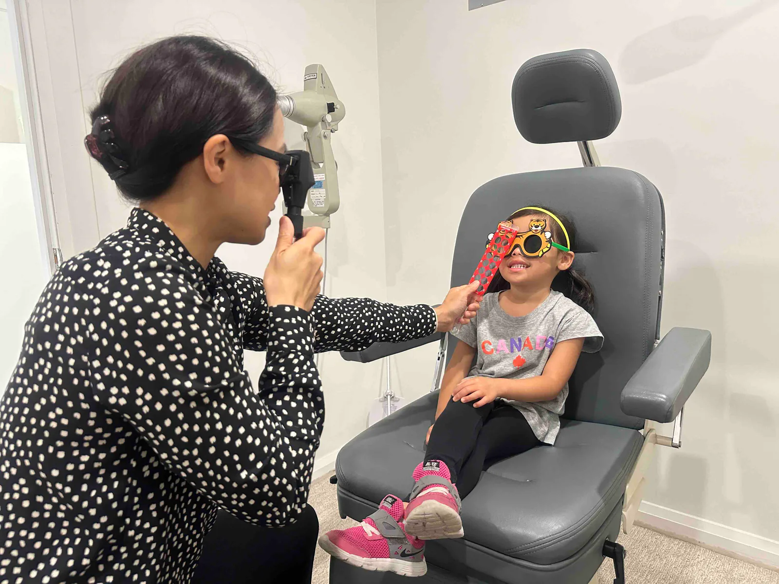Dr. Sarah Fong performing a pediatric eye exam at Boardwalk Eye Care in Cambridge, Ontario