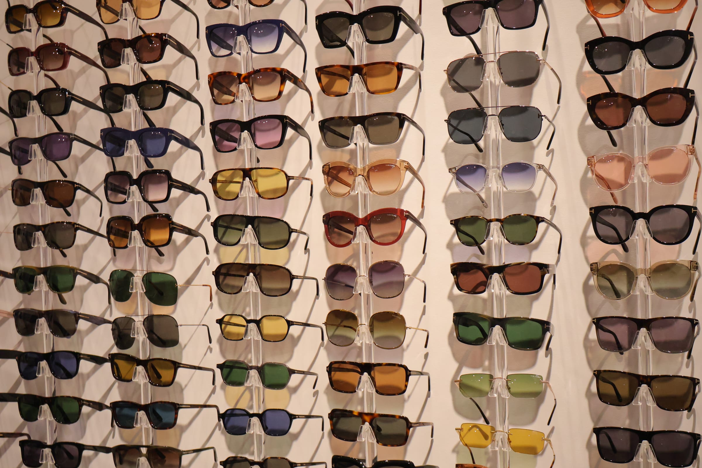 Designer sunglass wall in warm light at Boardwalk Eye Care in Cambridge