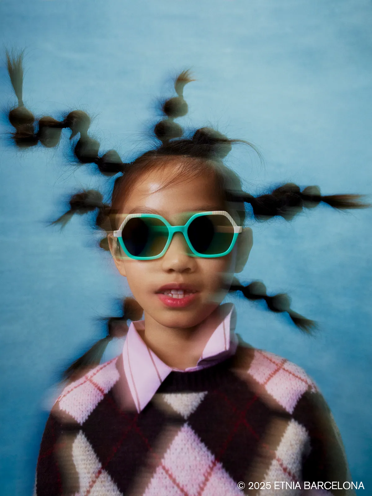 Boy making a playful face in tortoiseshell Etnia Barcelona kids' glasses, available at Boardwalk Eye Care in Cambridge, Ontario