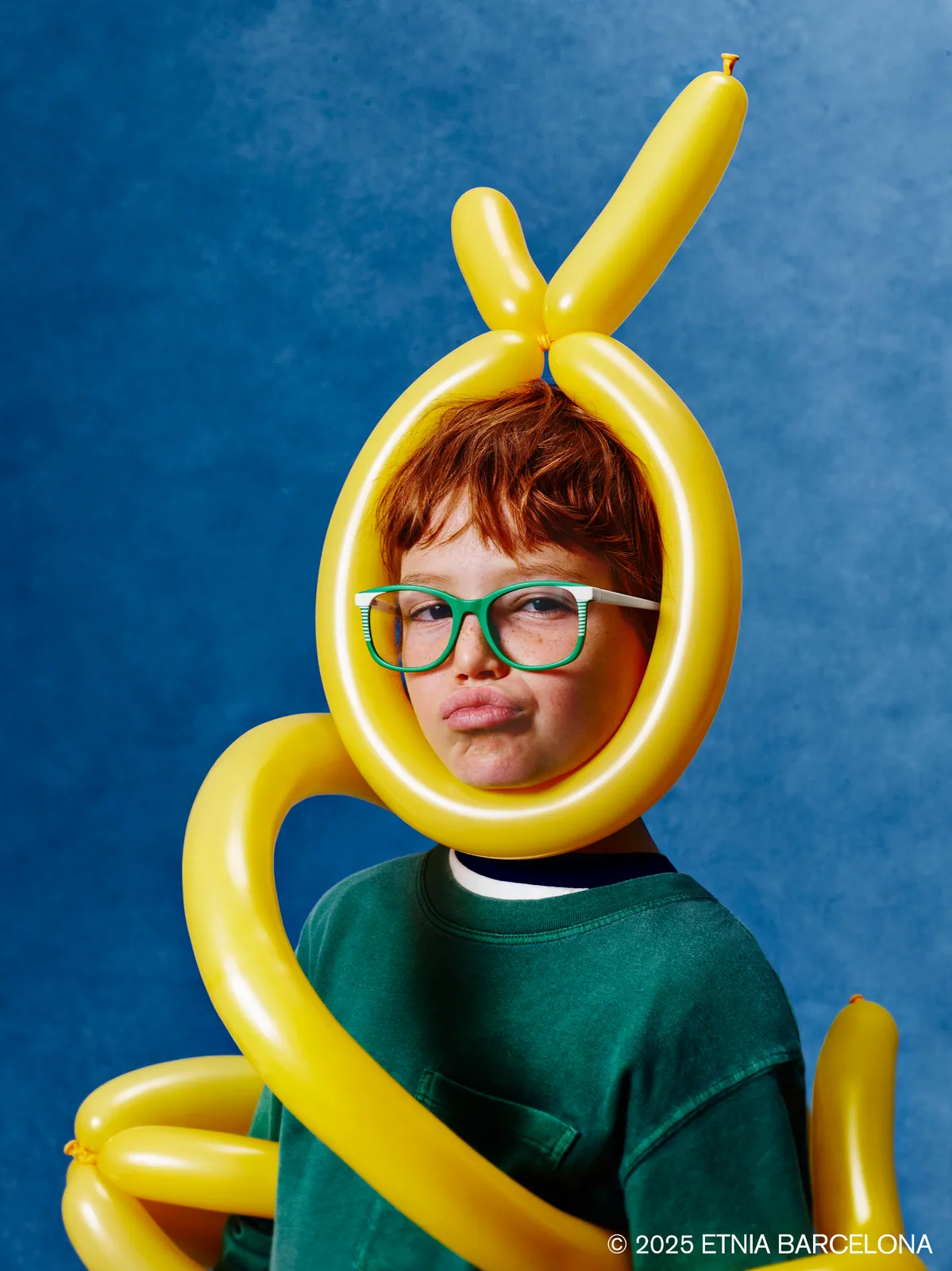 Boy resting his chin on a skateboard, wearing tortoiseshell Etnia Barcelona kids' glasses, available at Boardwalk Eye Care in Cambridge, Ontario