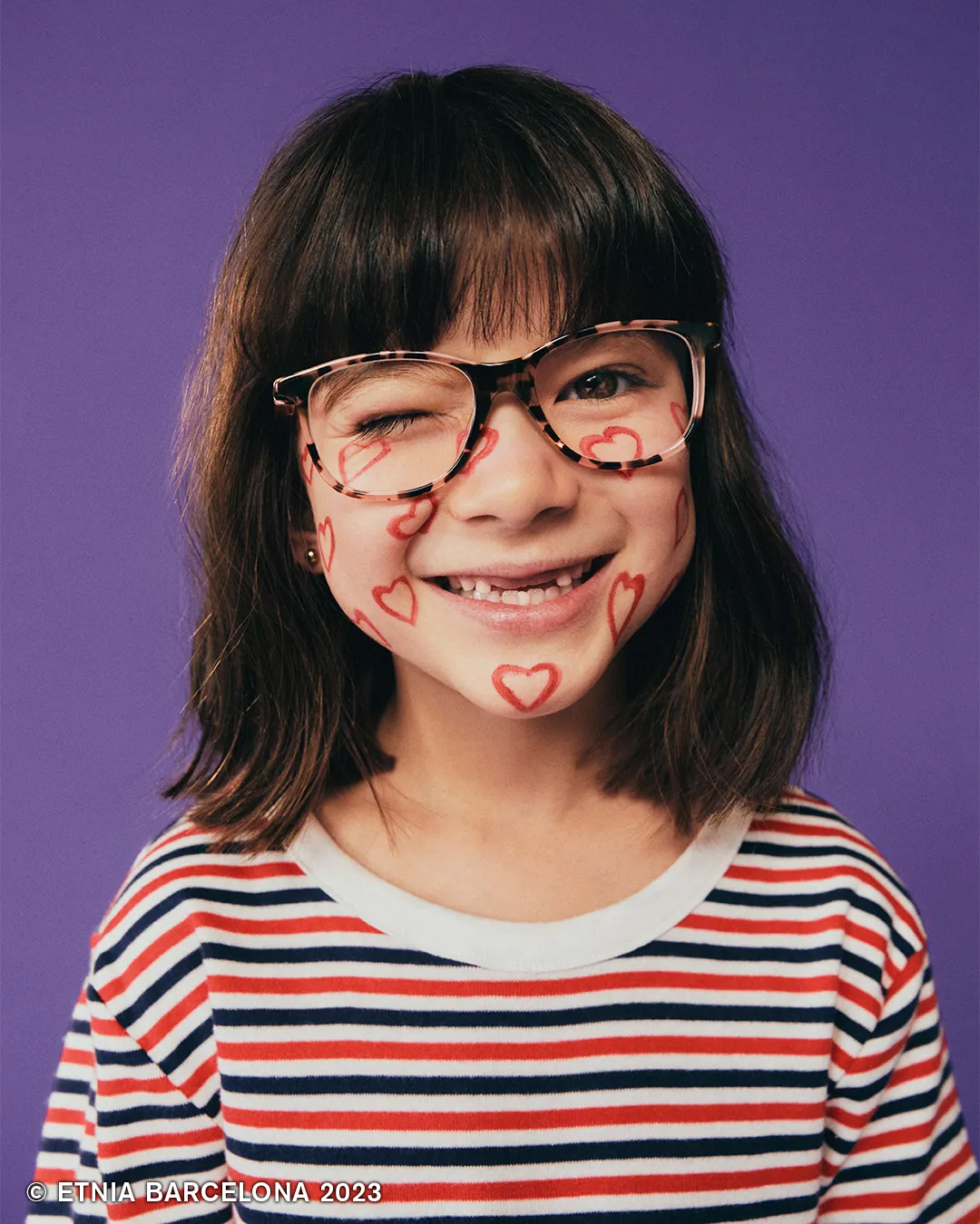 Girl in tortoiseshell Etnia Barcelona kids' glasses, available at Boardwalk Eye Care in Cambridge, Ontario