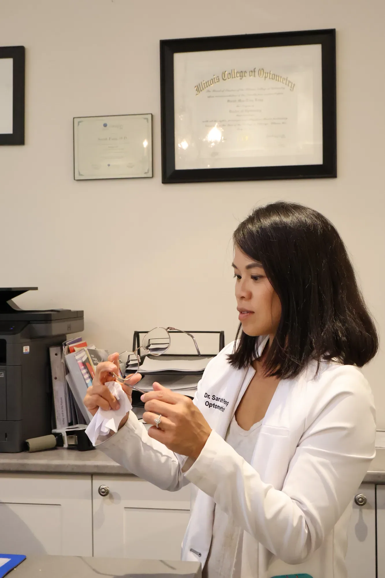 Dr. Sarah Fong adjusting eyeglasses at Boardwalk Eye Care in Cambridge